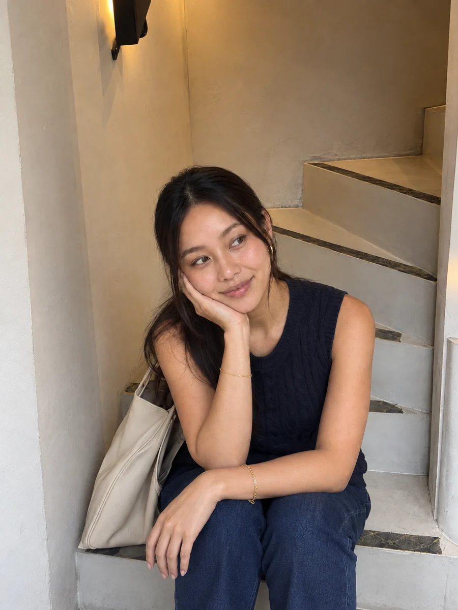 Bianca Lim seated beside a staircase.